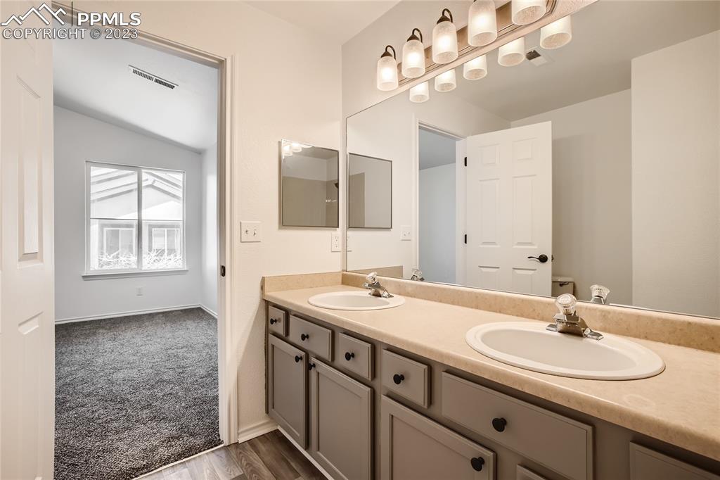 3764 Riviera Grove, Unit 203 Colorado Springs, CO 80922 - Photo 8 of 31 a bathroom with a sink double vanity and a mirror