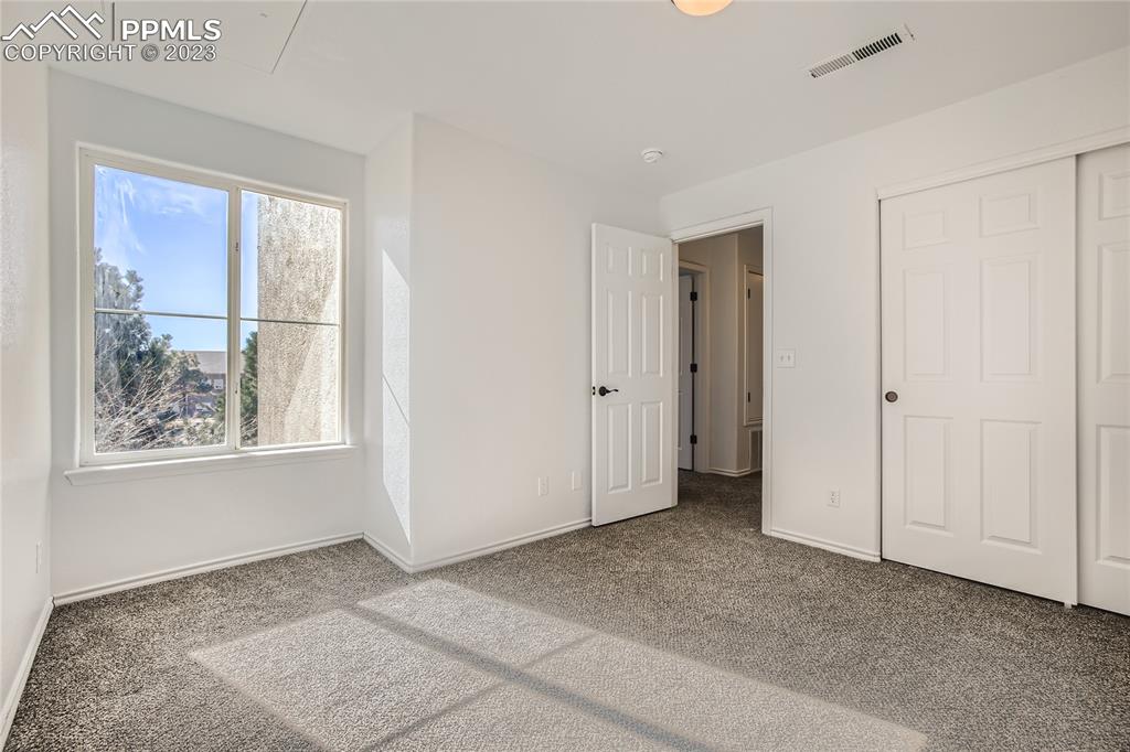 3764 Riviera Grove, Unit 203 Colorado Springs, CO 80922 - Photo 10 of 31 a view of an empty room with a window