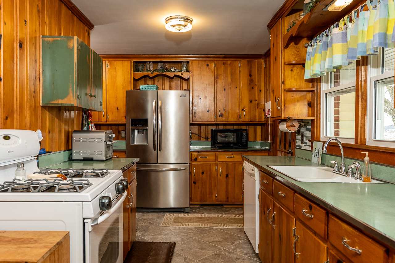 4273 Rockfish Road Grottoes, VA 24441 - Photo 15 of 48 a kitchen with stainless steel appliances granite countertop a refrigerator a stove and a sink with wooden floors