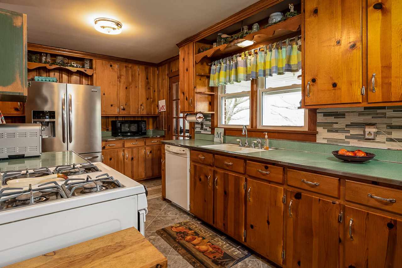 4273 Rockfish Road Grottoes, VA 24441 - Photo 16 of 48 a kitchen with granite countertop a sink stove and refrigerator