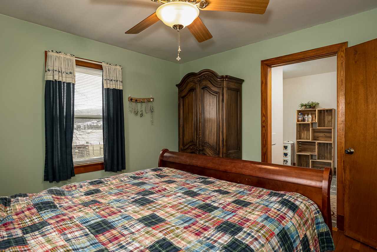 4273 Rockfish Road Grottoes, VA 24441 - Photo 24 of 48 a bedroom with a large bed and a chandelier