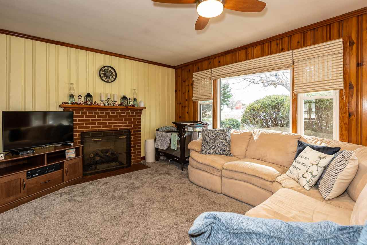 4273 Rockfish Road Grottoes, VA 24441 - Photo 6 of 48 a living room with furniture a flat screen tv and a fireplace