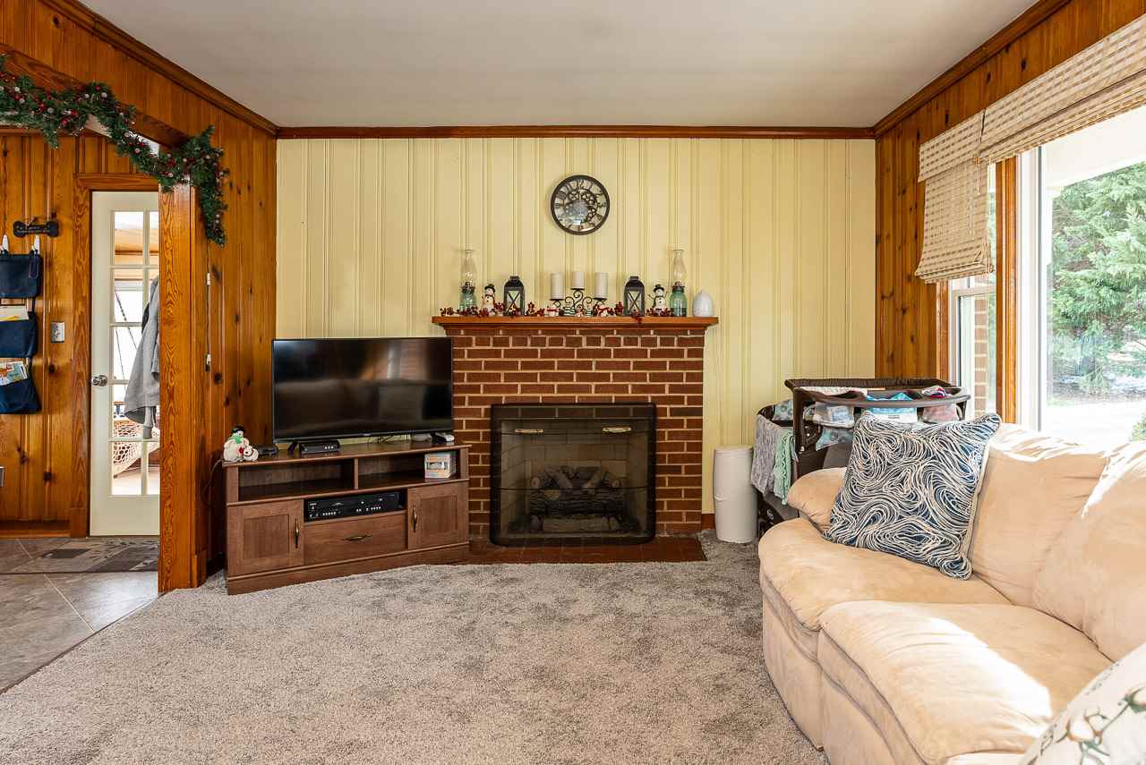 4273 Rockfish Road Grottoes, VA 24441 - Photo 8 of 48 a living room with furniture a flat screen tv and a fireplace