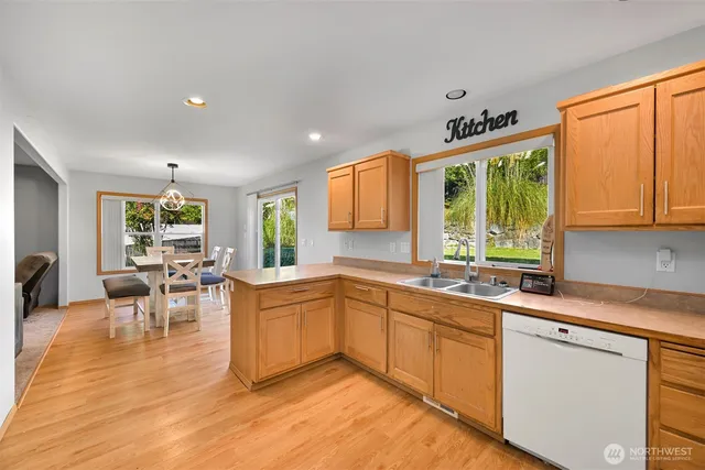 a view of a living room hardwood floor and a window