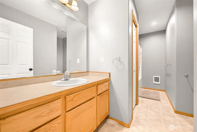 an empty room with windows and cabinet