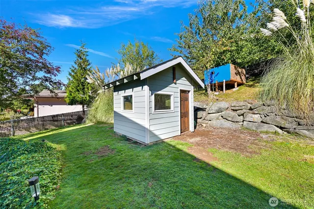 a view of yard with swimming pool and green space