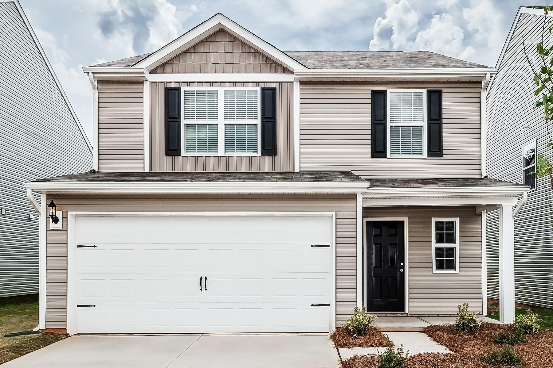 a front view of a house with a garage