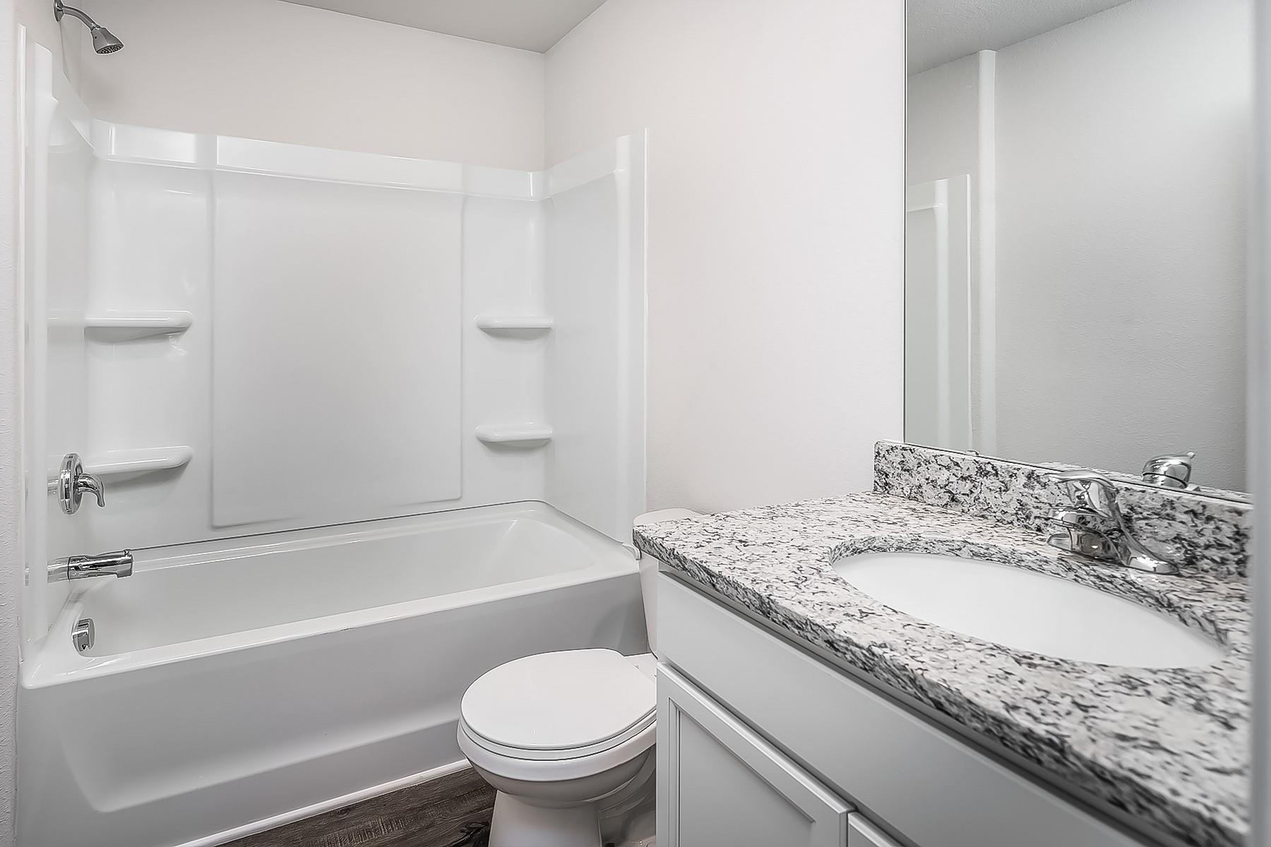 1301 Nia Road Charlotte, NC 28215 - Photo 14 of 15 a bathroom with a granite countertop toilet sink and bathtub