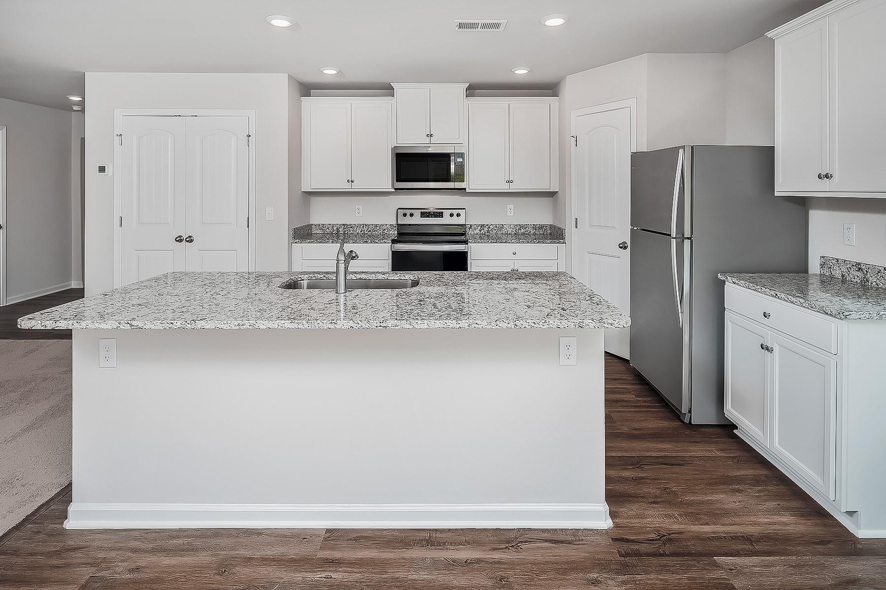 1301 Nia Road Charlotte, NC 28215 - Photo 5 of 15 a kitchen with stainless steel appliances granite countertop a refrigerator a stove a sink and white cabinets