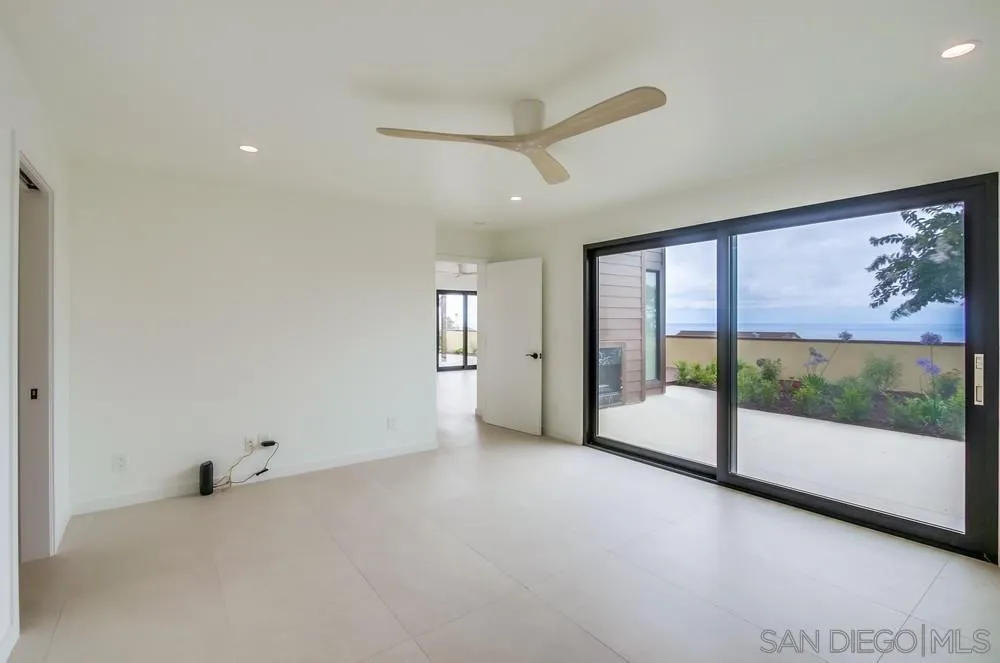 14066 Crest Way Del Mar, CA 92014 - Photo 12 of 32 a view of an empty room with a sliding door