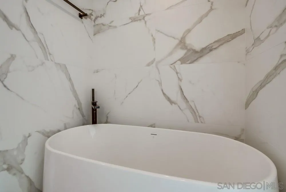 14066 Crest Way Del Mar, CA 92014 - Photo 18 of 32 a bathroom with a white bath tub and a shower