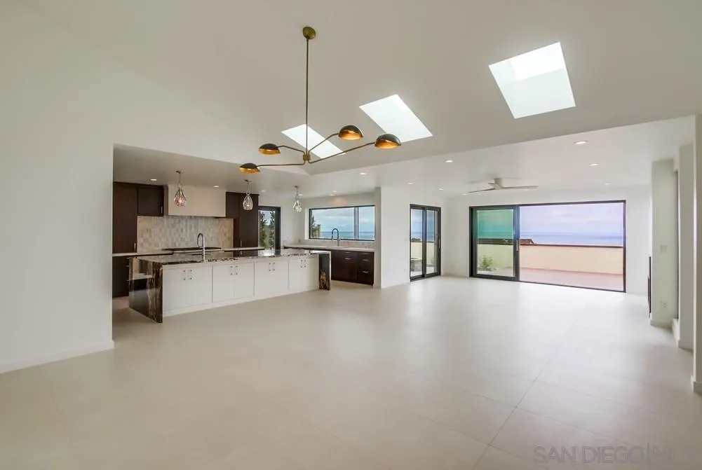 14066 Crest Way Del Mar, CA 92014 - Photo 3 of 32 a view of a kitchen with a sink and a fireplace