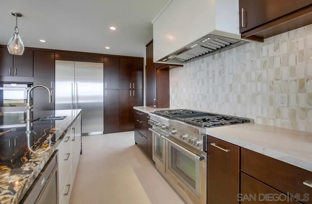 14066 Crest Way Del Mar, CA 92014 - Photo 9 of 32 a kitchen with granite countertop a stove and a sink