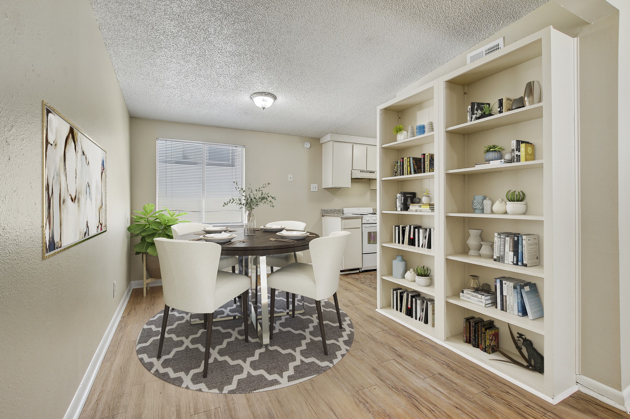 a view of a dining room with furniture and a book shelf