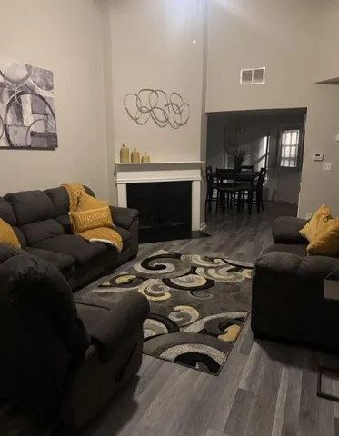 a living room with furniture and wooden floor