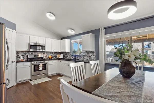 a view of an entryway with wooden floor