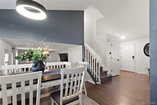 a vase of flowers sitting on a table with floor to ceiling window