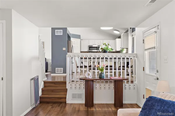 a vase of flowers sitting on a table in front of a window