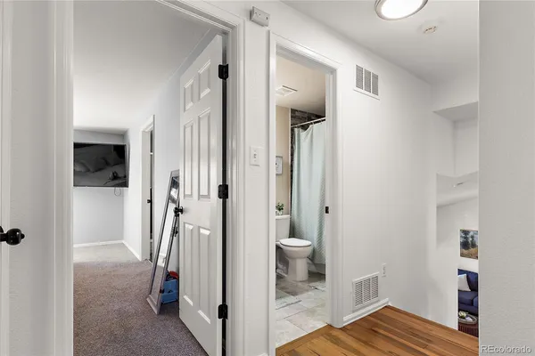 a bedroom with a bed and a painting on the wall