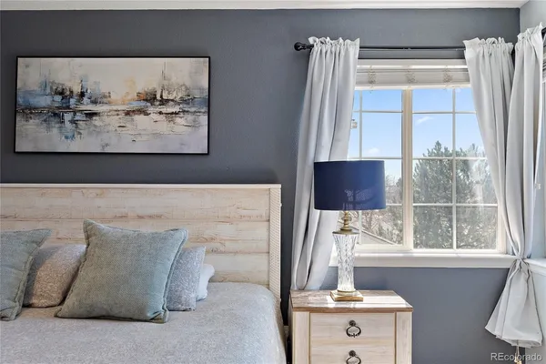 a bedroom with a large bed and a flat screen tv