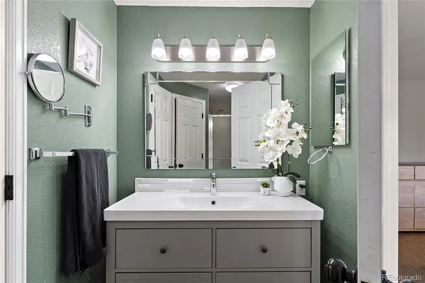 a white toilet sitting next to a bathroom sink