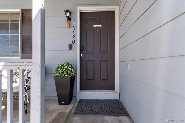 a living room with furniture and kitchen view