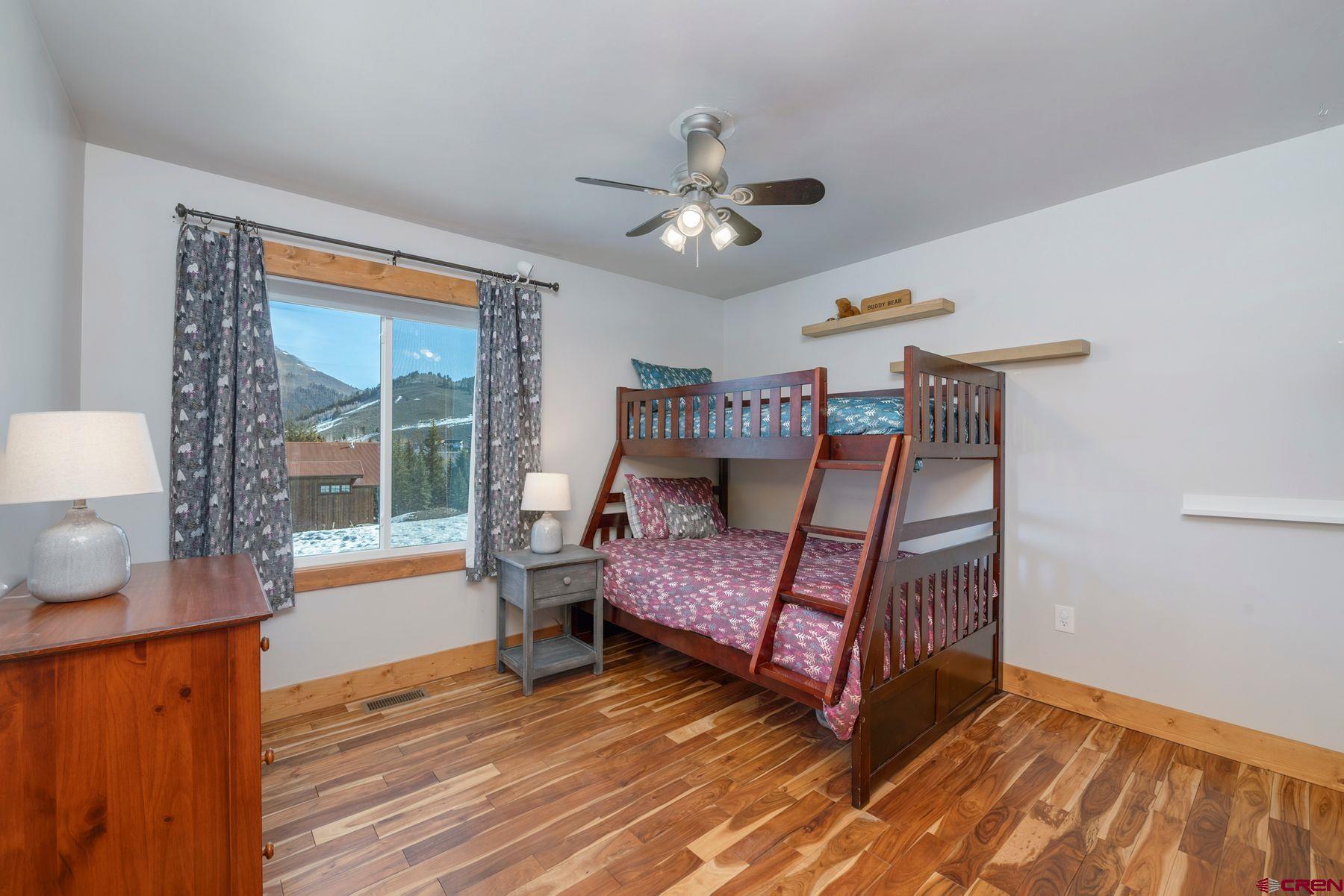 86 Jacquelyn Lane Crested Butte, CO 81224 - Photo 14 of 29 a bedroom with a bed and wooden floor
