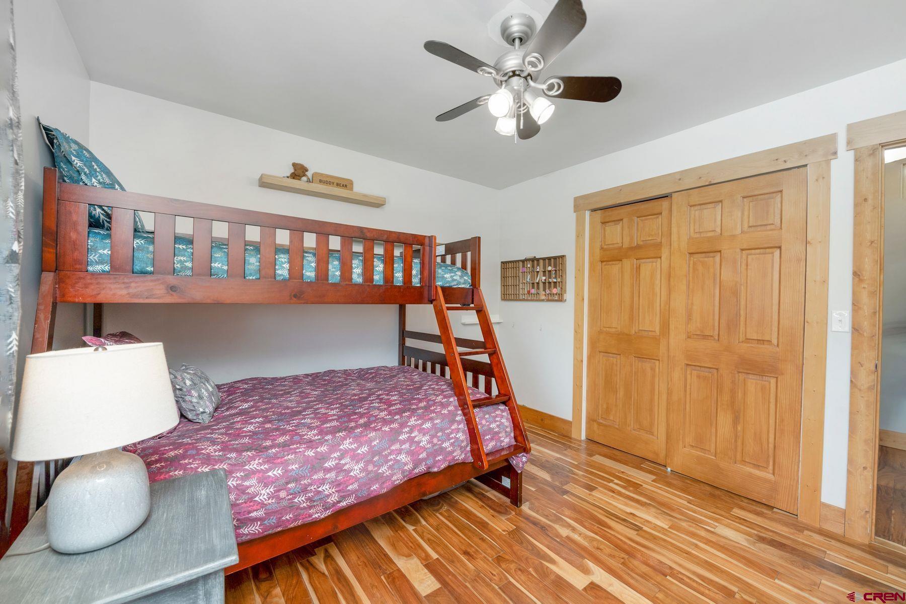 86 Jacquelyn Lane Crested Butte, CO 81224 - Photo 15 of 29 a bedroom with a bed and a chandelier