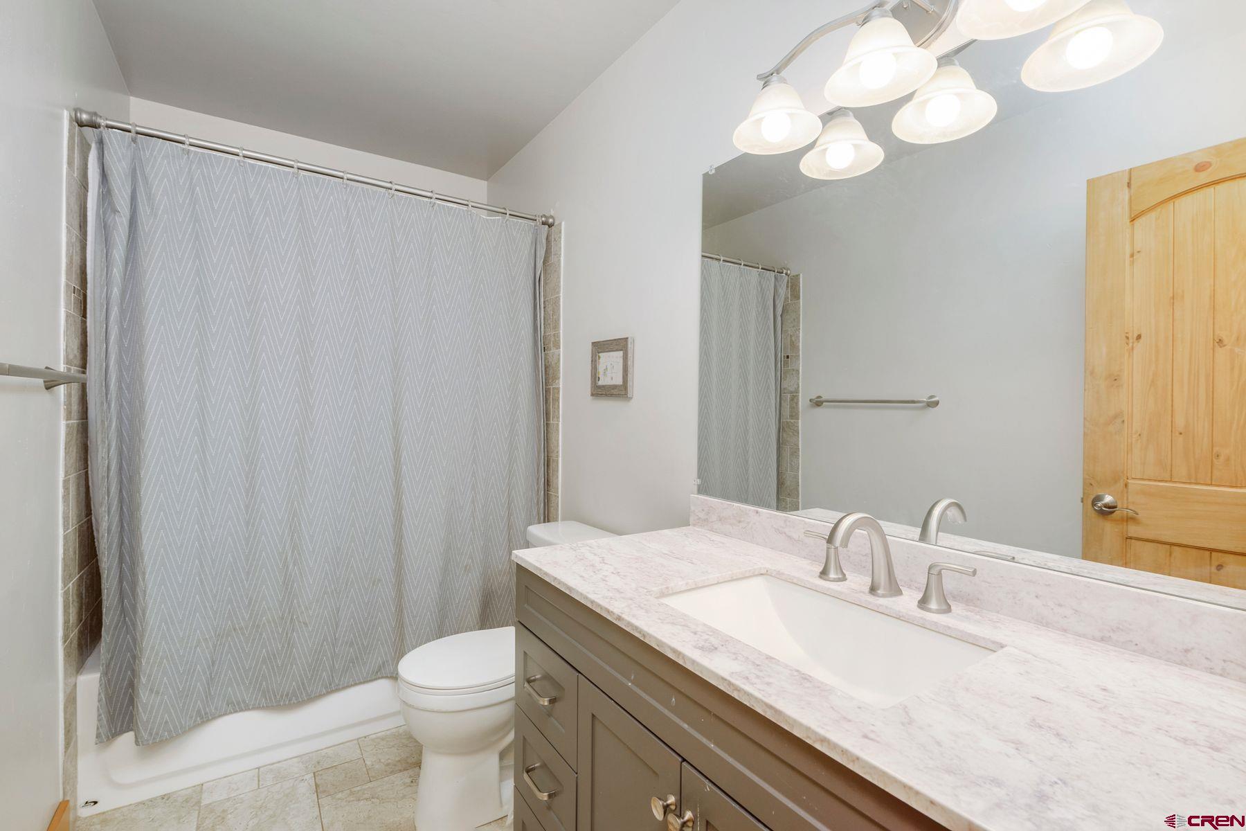 86 Jacquelyn Lane Crested Butte, CO 81224 - Photo 16 of 29 a bathroom with a granite countertop sink toilet and a mirror