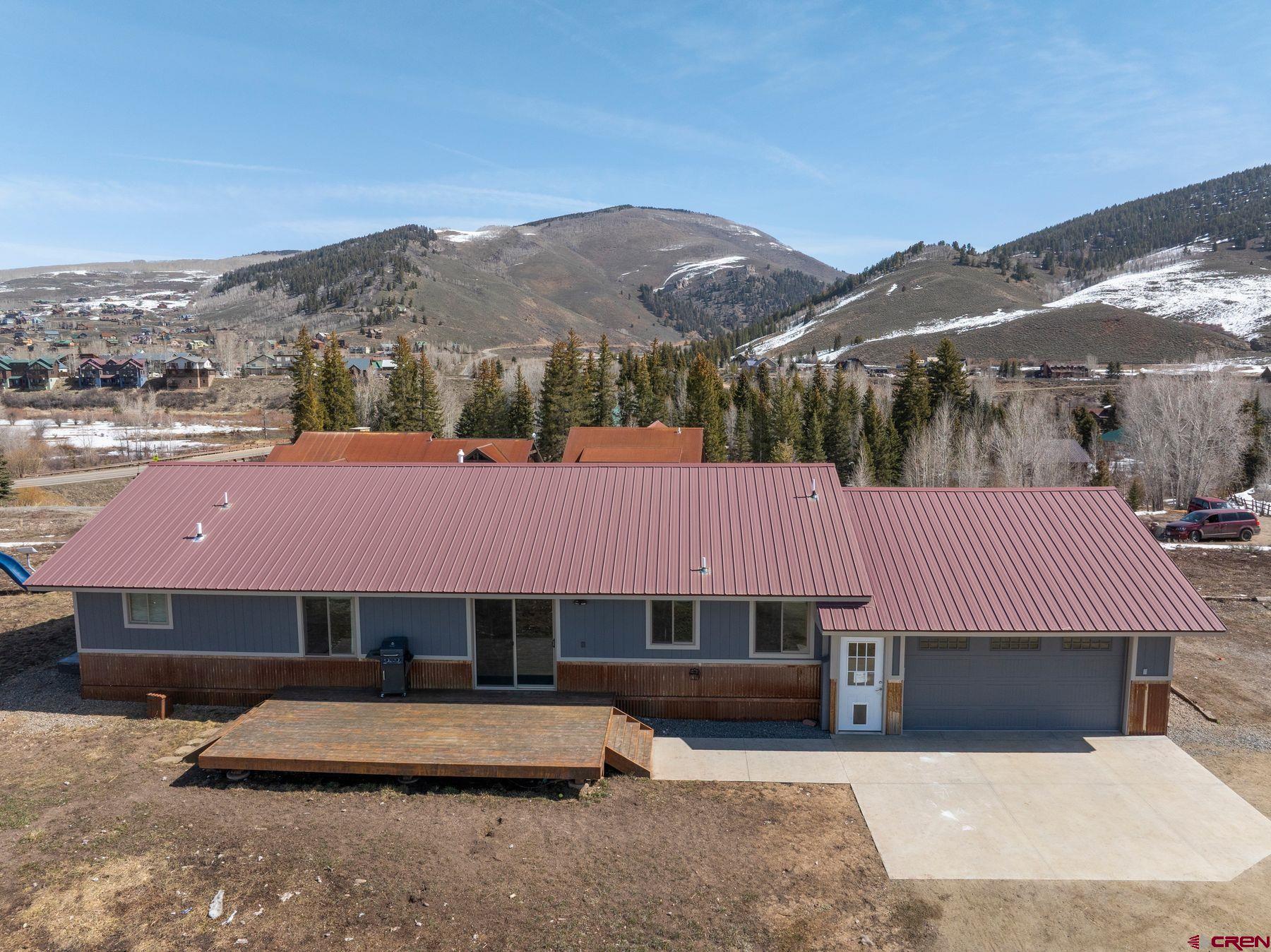 86 Jacquelyn Lane Crested Butte, CO 81224 - Photo 22 of 29 a front view of a house with a yard and mountain