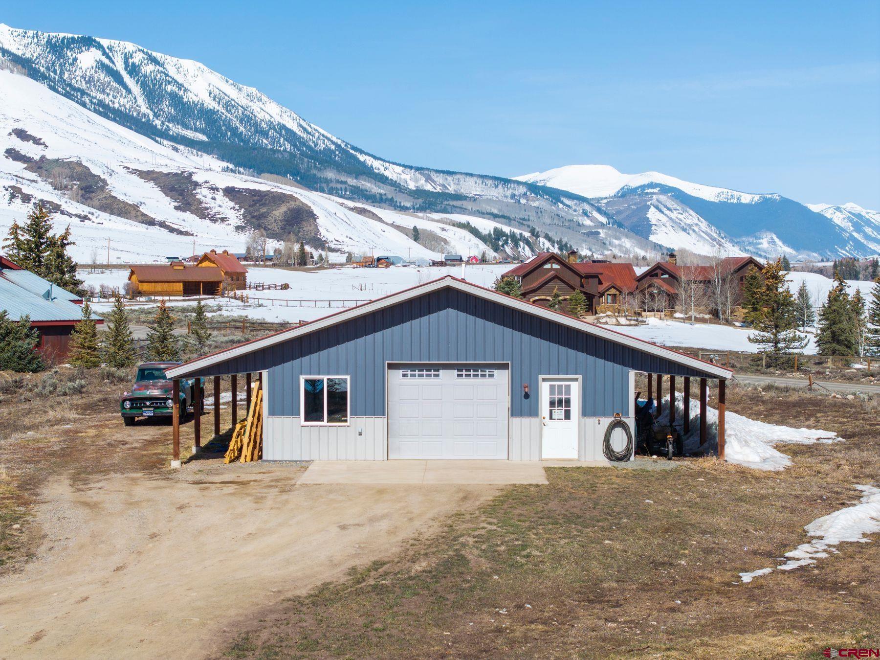 86 Jacquelyn Lane Crested Butte, CO 81224 - Photo 24 of 29 a front view of a house with a yard and parking space