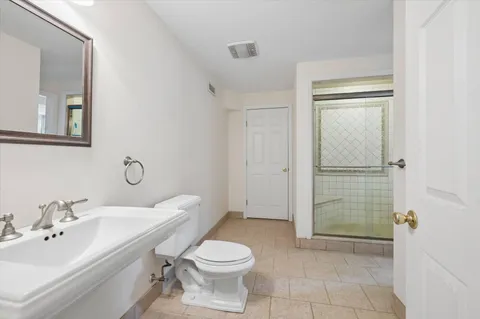 a bathroom with a toilet sink and shower