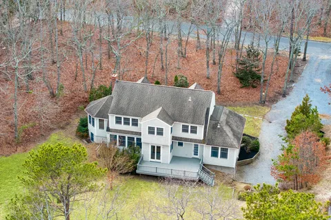 an aerial view of a house with a yard