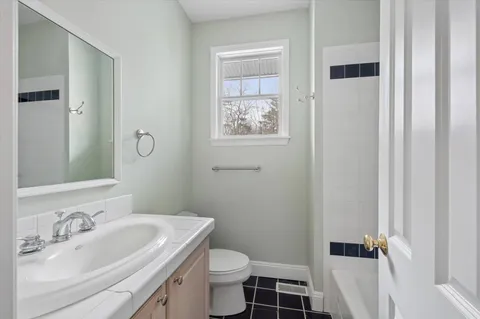 a bathroom with a sink toilet and vanity