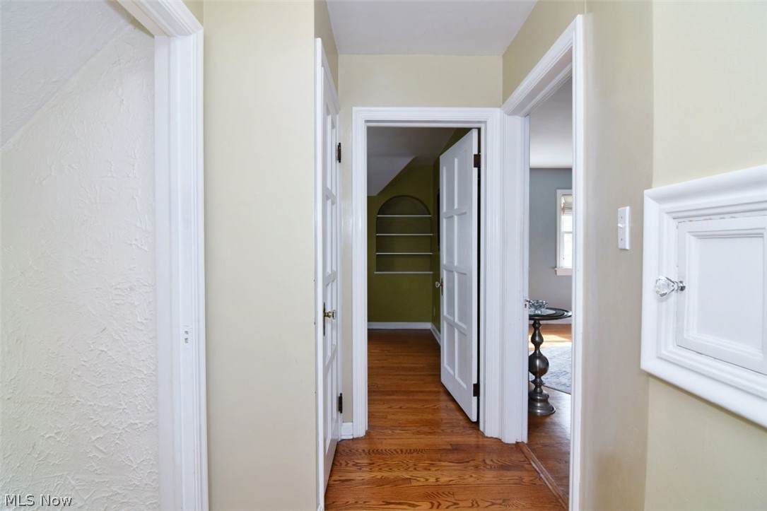 3451 Edison Road Cleveland Heights, OH 44121 - Photo 24 of 46 Hardwood flooring, painted walls, white trim, and a built-in arched shelving unit