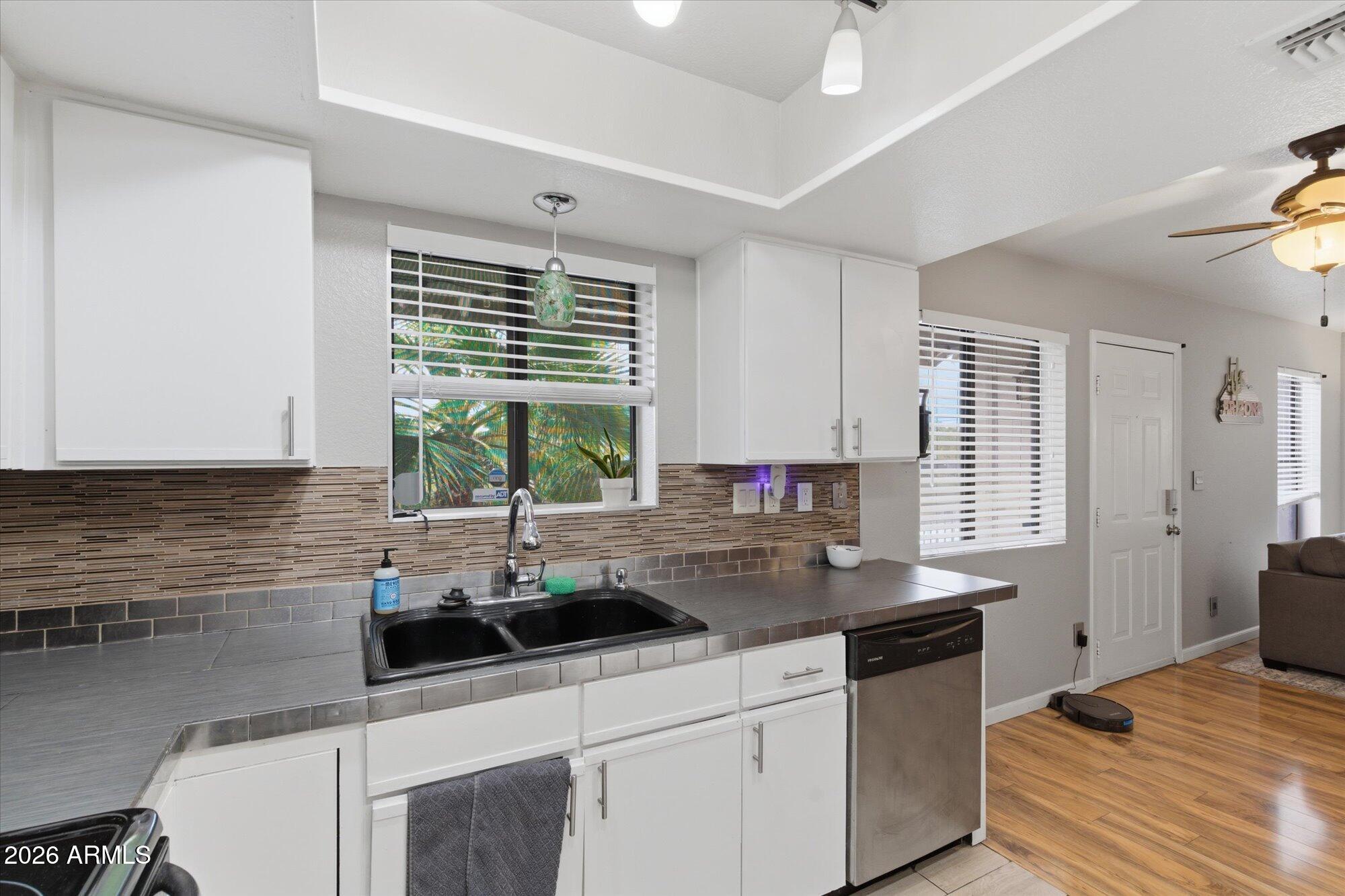 3635 North 37th Street, Unit 10 Phoenix, AZ 85018 - Photo 11 of 26 a kitchen with stainless steel appliances granite countertop a sink a stove a refrigerator and cabinets