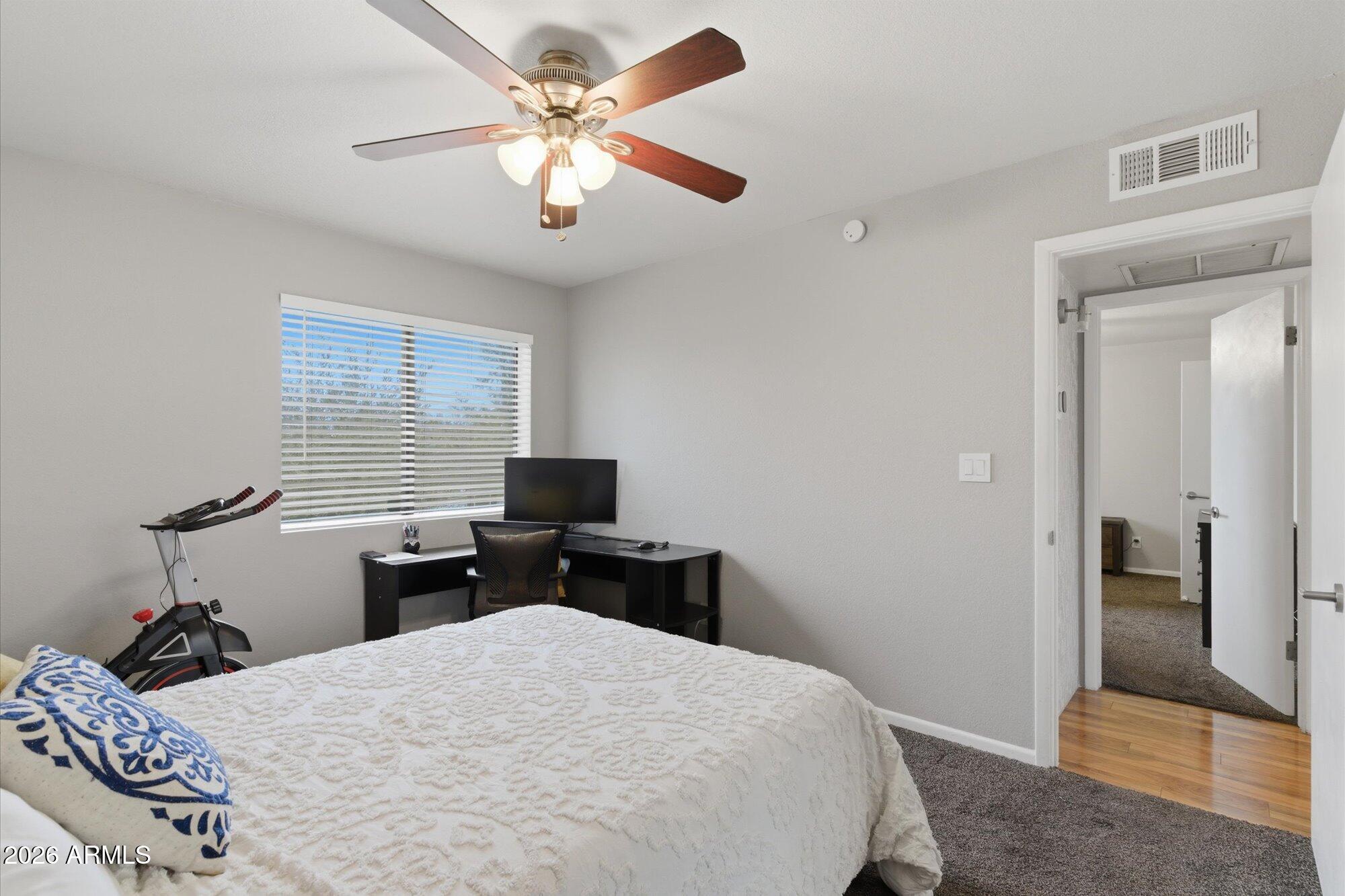 3635 North 37th Street, Unit 10 Phoenix, AZ 85018 - Photo 14 of 26 a bedroom with a bed and a chandelier