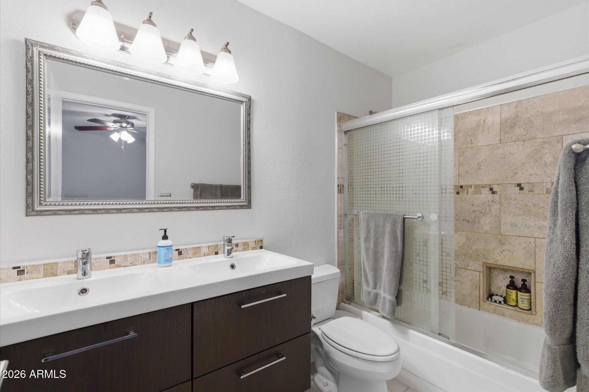 3635 North 37th Street, Unit 10 Phoenix, AZ 85018 - Photo 15 of 26 a bathroom with a sink a toilet and shower