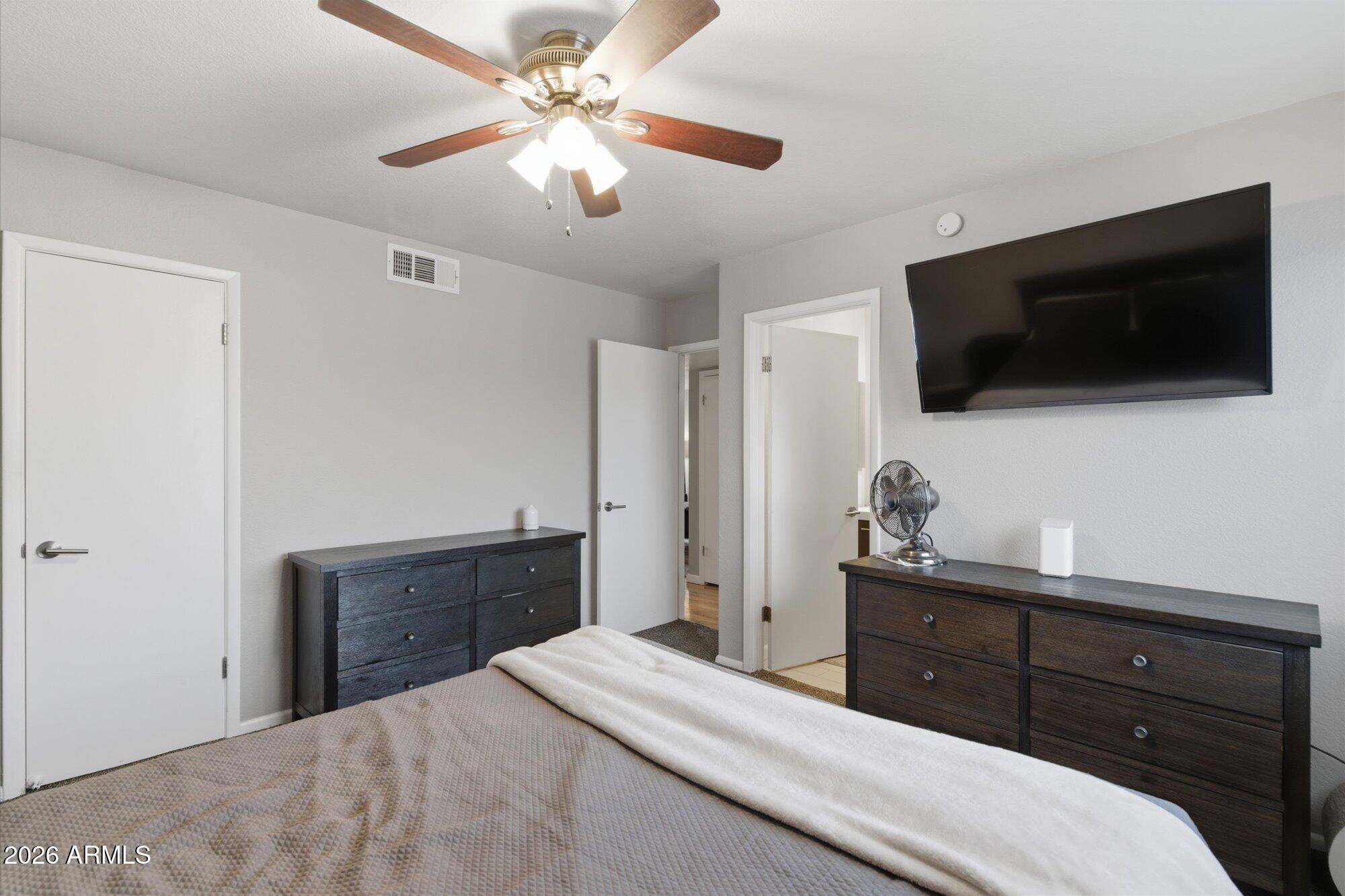 3635 North 37th Street, Unit 10 Phoenix, AZ 85018 - Photo 17 of 26 a bedroom with a bed and a flat screen tv