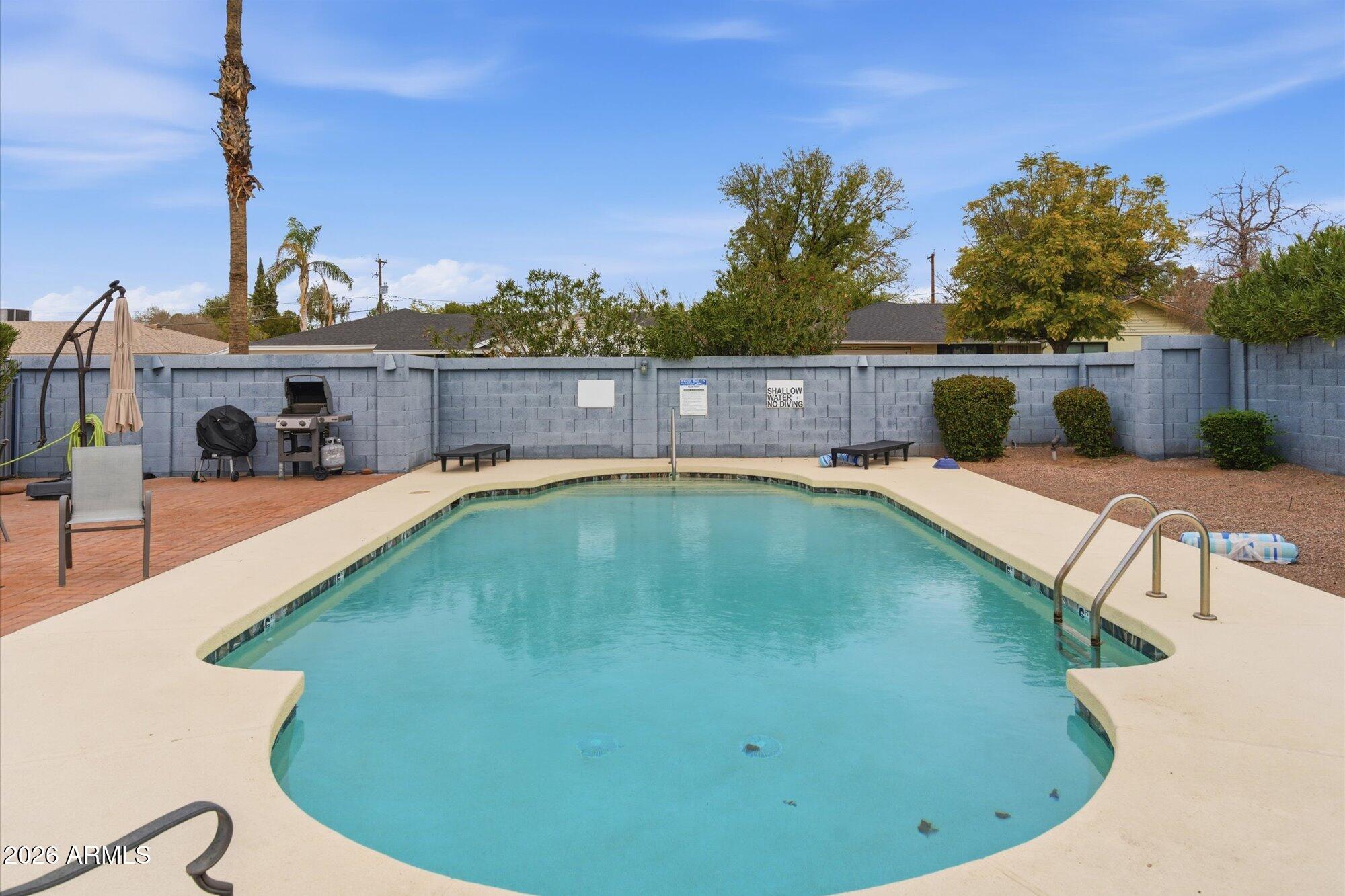 3635 North 37th Street, Unit 10 Phoenix, AZ 85018 - Photo 20 of 26 a view of a swimming pool with a patio