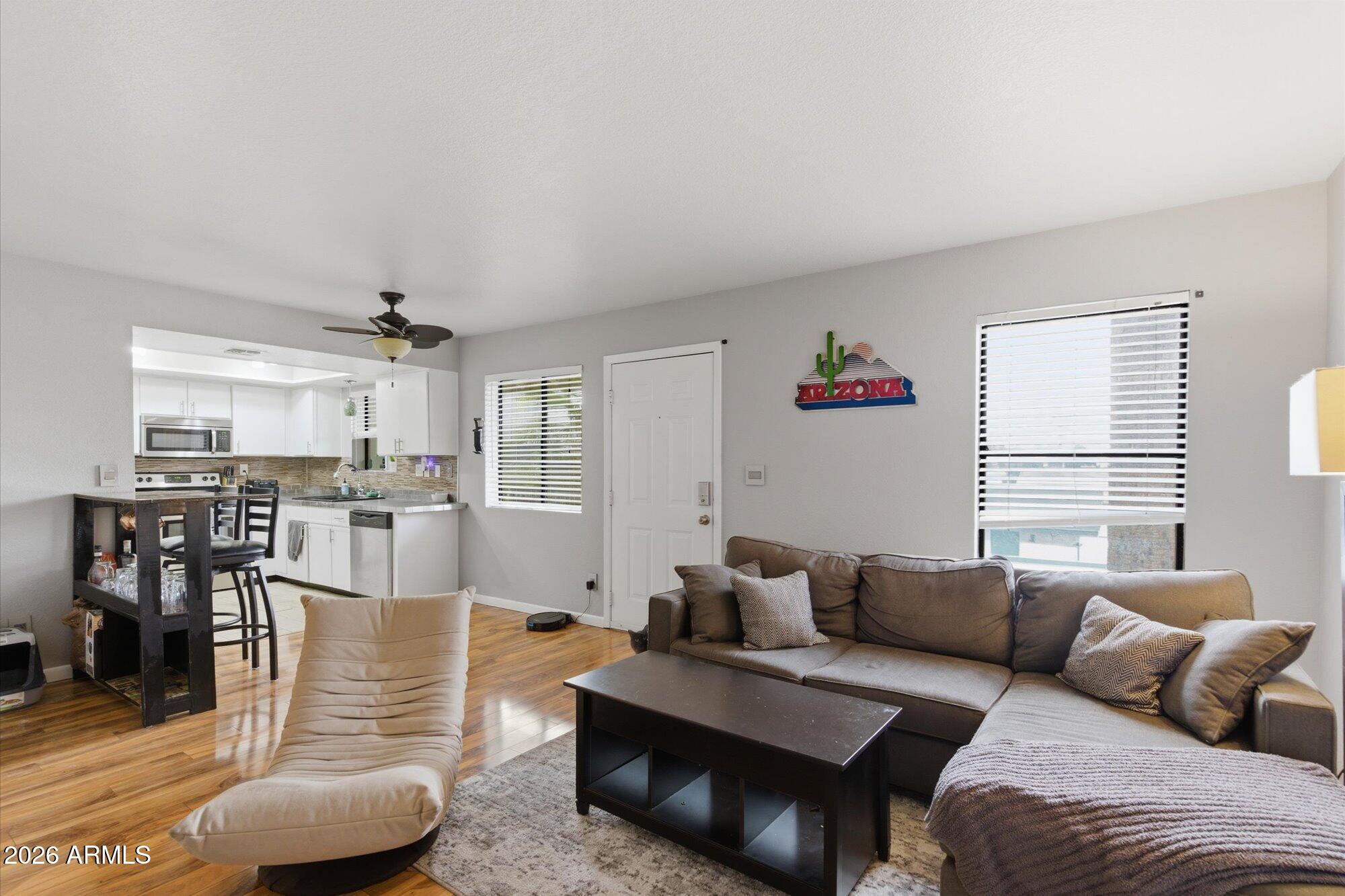 3635 North 37th Street, Unit 10 Phoenix, AZ 85018 - Photo 2 of 26 a living room with furniture and wooden floor