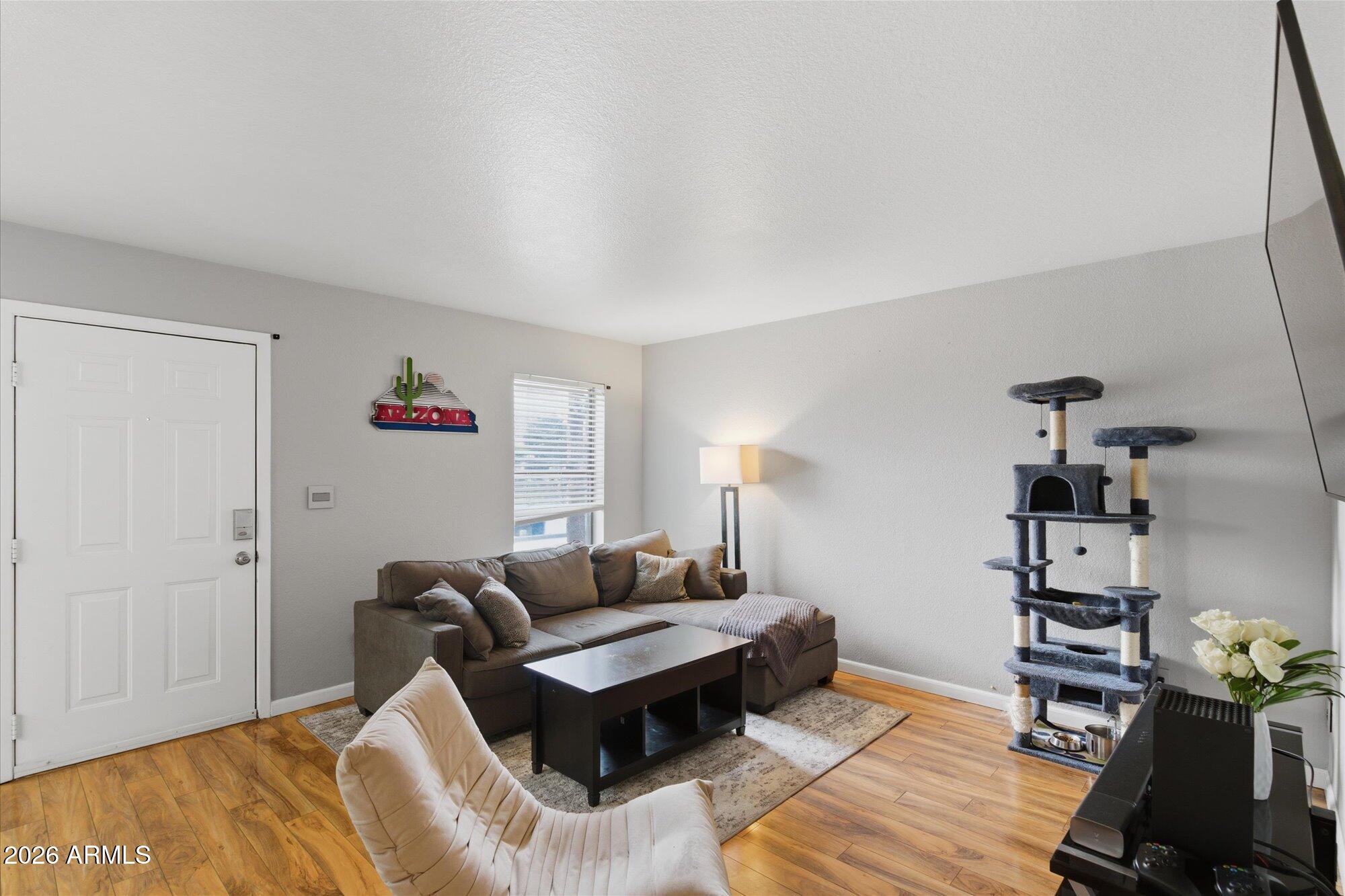 3635 North 37th Street, Unit 10 Phoenix, AZ 85018 - Photo 3 of 26 a living room with furniture and wooden floor