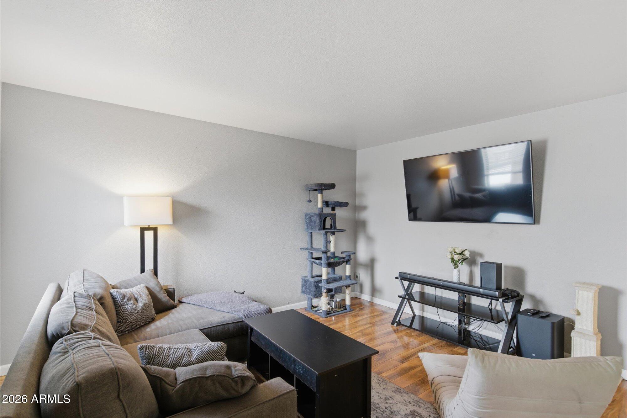 3635 North 37th Street, Unit 10 Phoenix, AZ 85018 - Photo 4 of 26 a living room with furniture and a flat screen tv