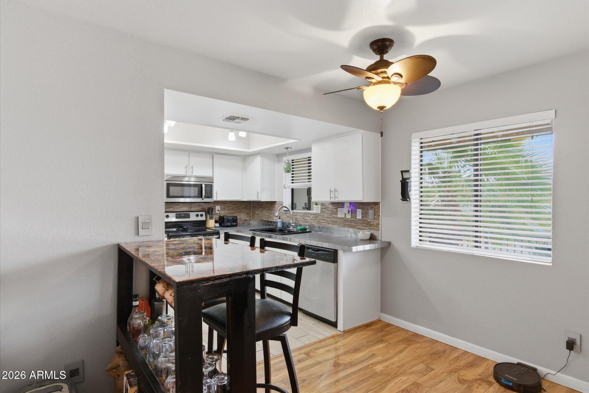 3635 North 37th Street, Unit 10 Phoenix, AZ 85018 - Photo 7 of 26 a kitchen with a table and chairs