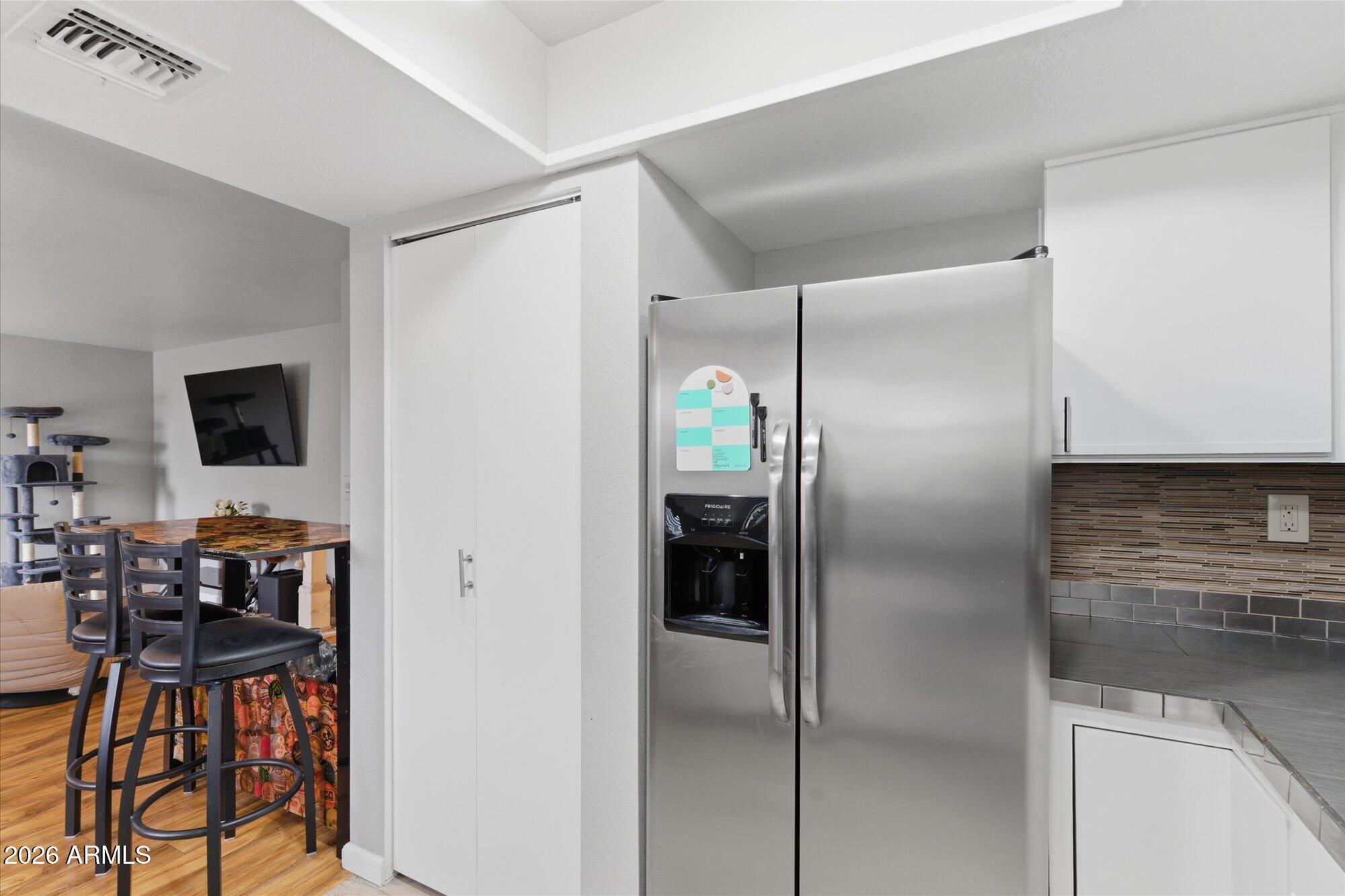 3635 North 37th Street, Unit 10 Phoenix, AZ 85018 - Photo 8 of 26 a kitchen with stainless steel appliances kitchen island a refrigerator sink and microwave