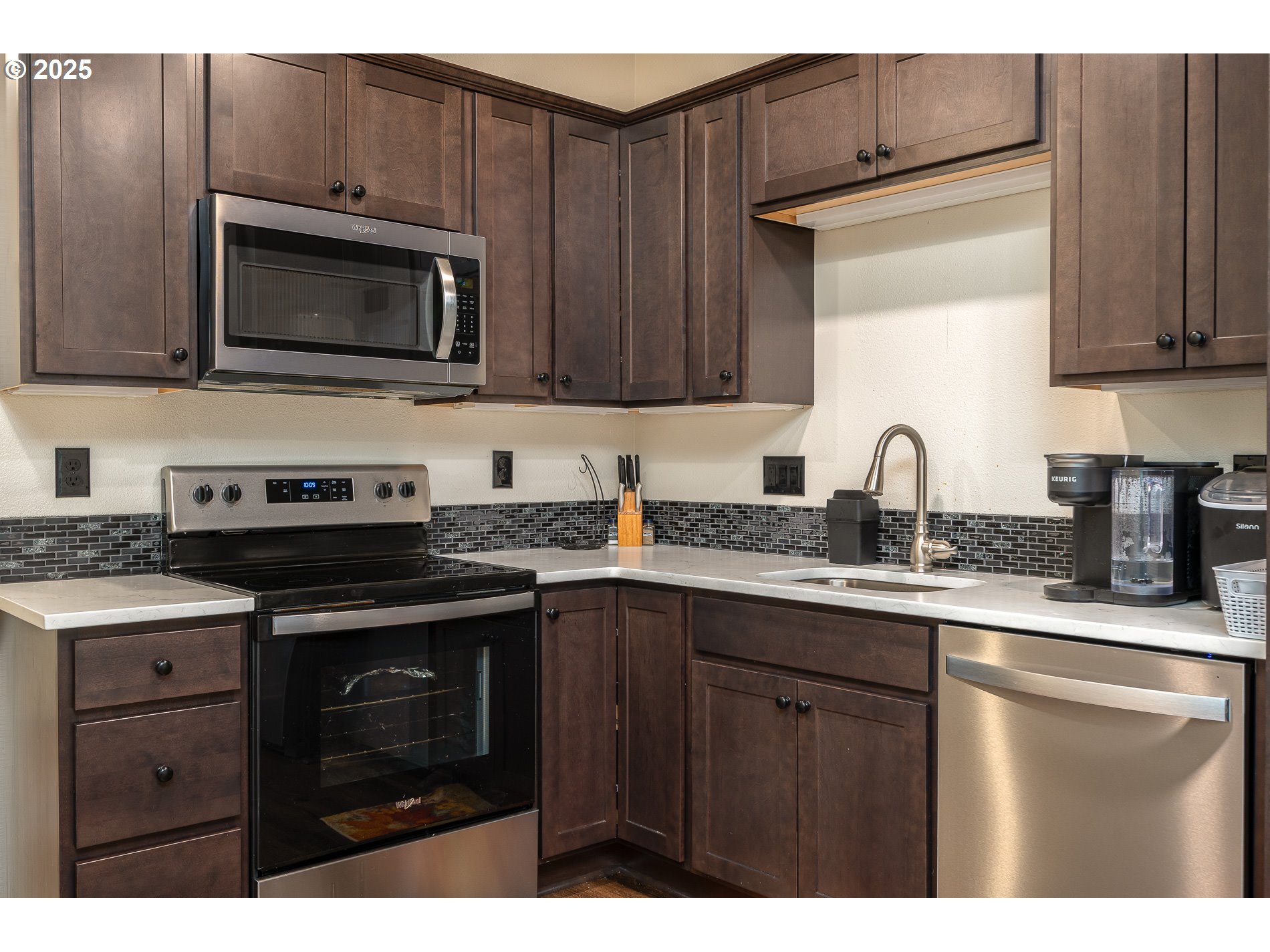 2314 Southwest 43rd Street Gresham, OR 97080 - Photo 26 of 36 a kitchen with stainless steel appliances granite countertop a stove microwave and sink