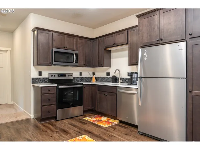 a kitchen with a refrigerator stove and microwave