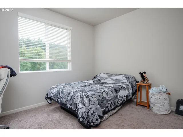 a bed sitting in a bedroom next to a window