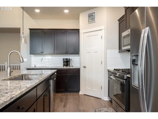 a kitchen with a refrigerator sink and stove
