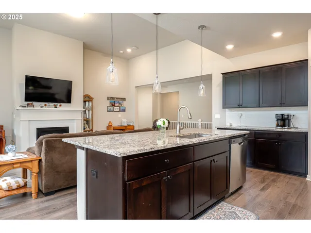 a kitchen with a sink a counter space appliances and cabinets